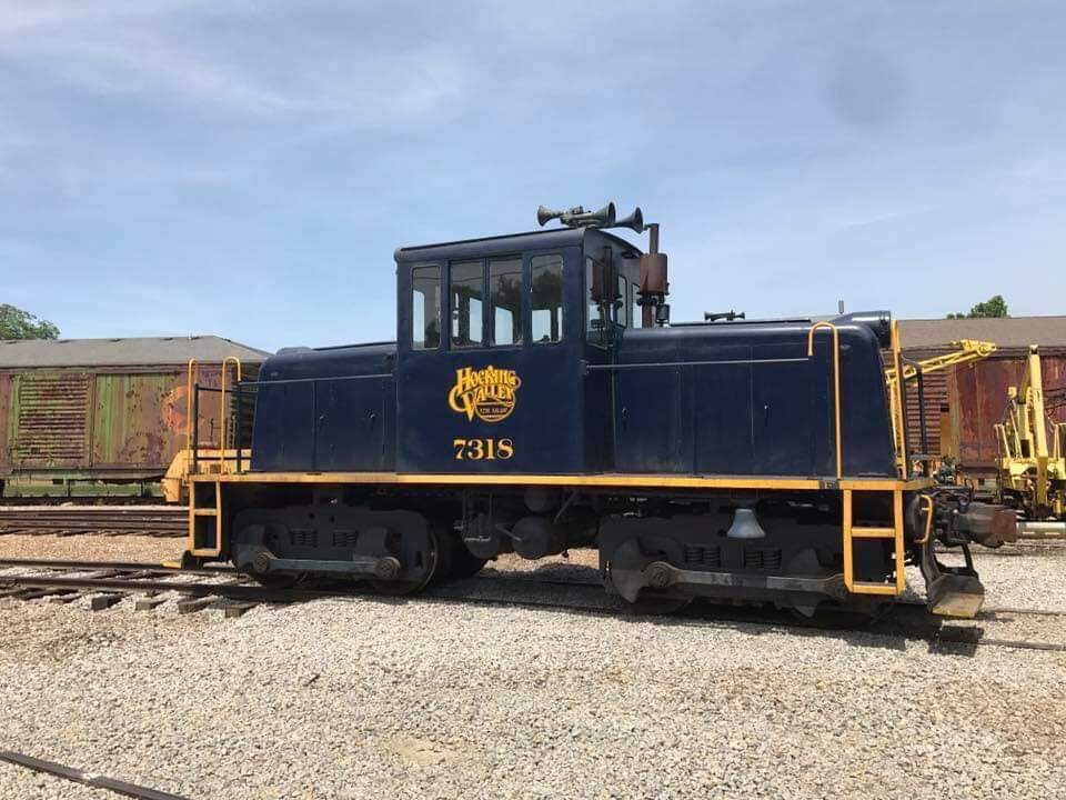 a train is parked on a dirt track