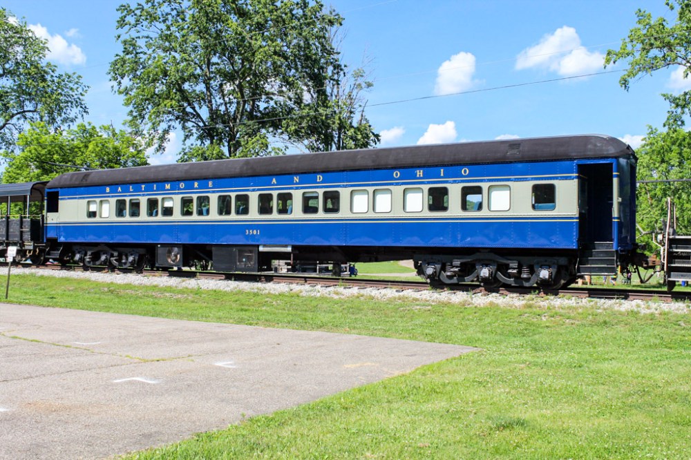 a blue train going down the track