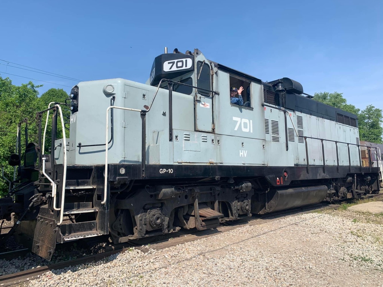 a train is parked on a dirt track