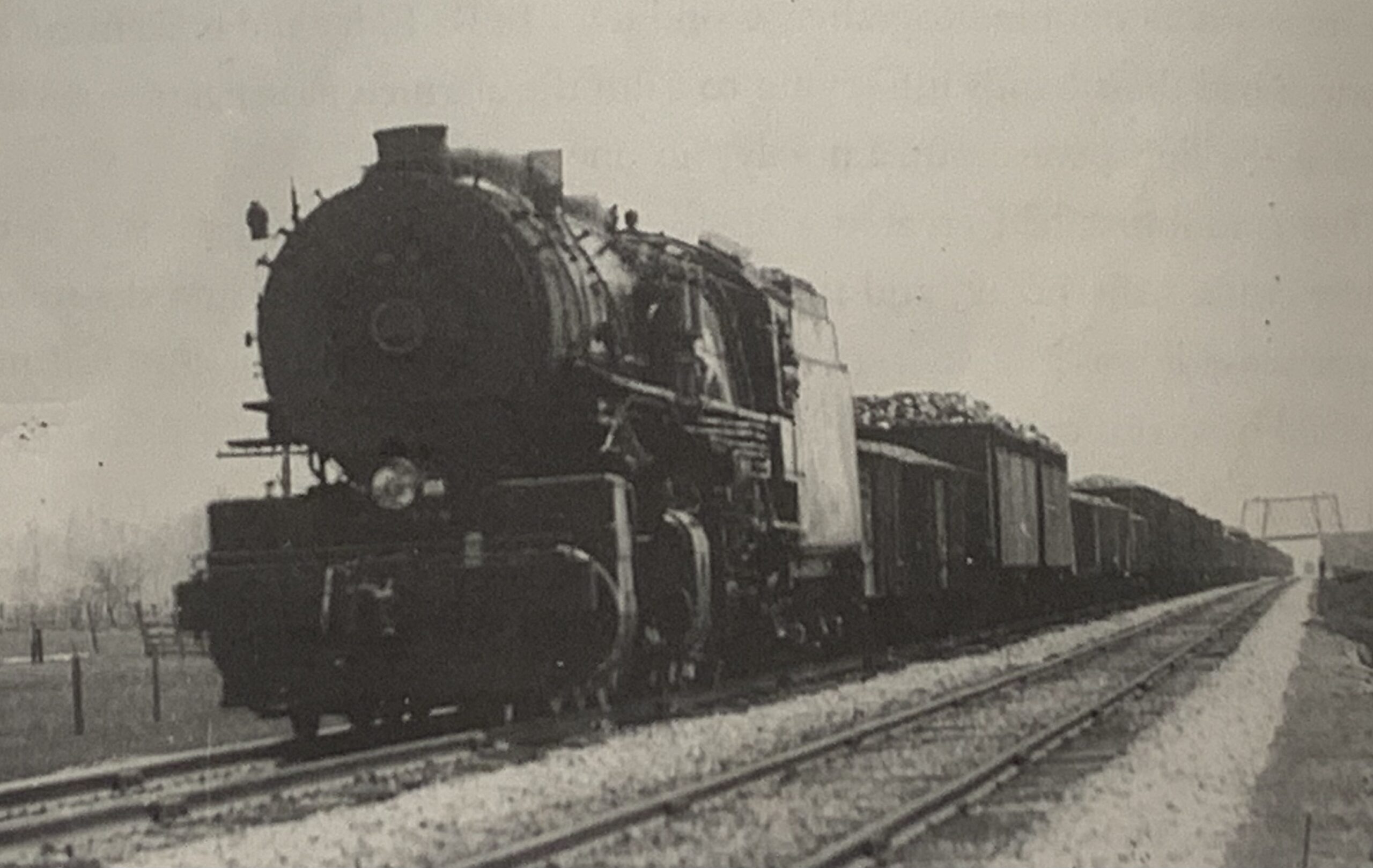 a steam engine train traveling down train tracks