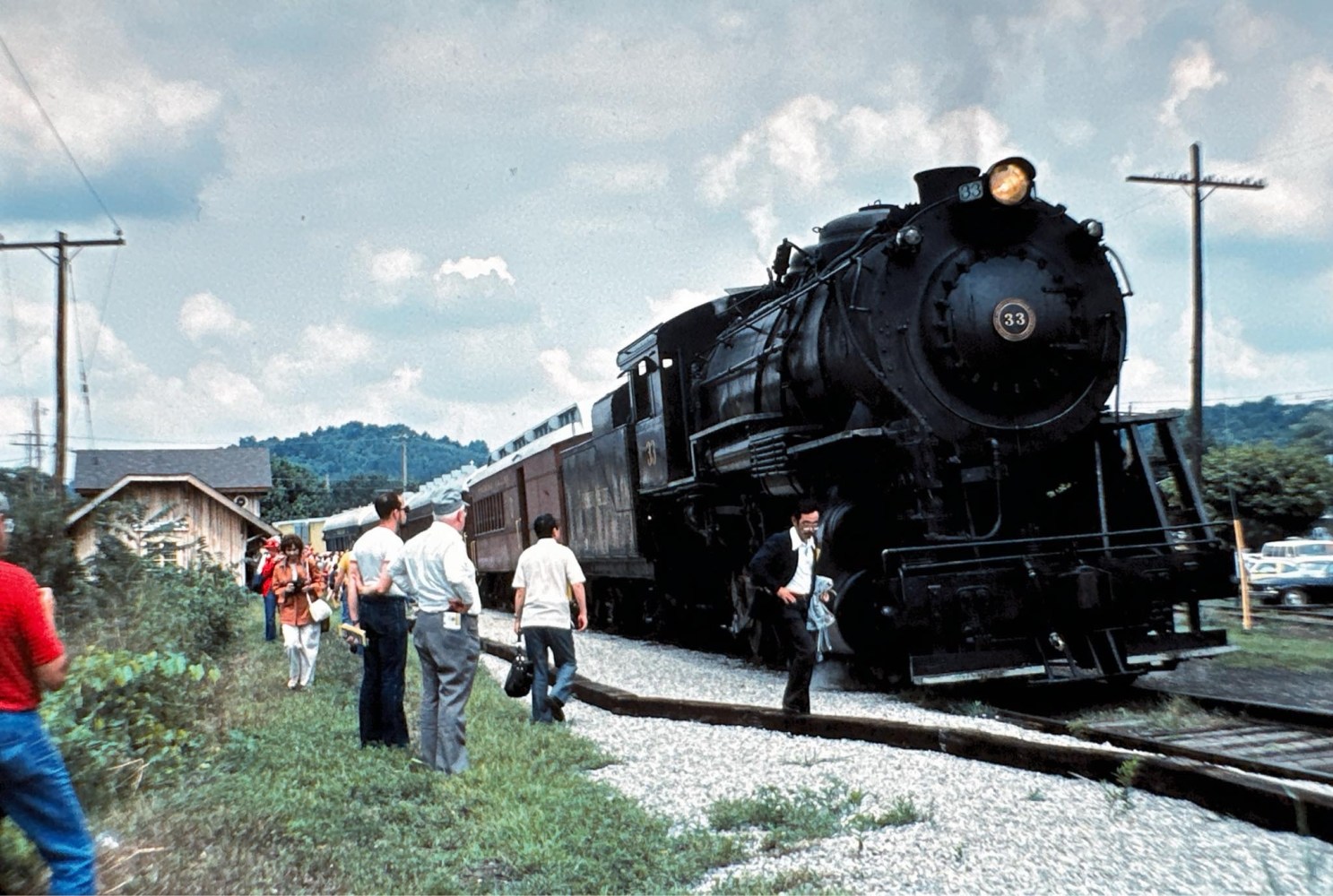 a group of people standing next to a train